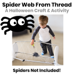 Young boy cutting a homemade spider web made from white thread, with a paper spider and a cartoon spider illustration. Halloween craft activity for kids.