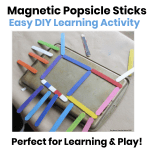 Colorful homemade magnetic popsicle sticks arranged to create a house on a metal cookie sheet, showing a fun DIY learning activity for kids.